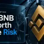 Gold BNB symbol sculpture on a vault door illustrating whether BNB is a good investment