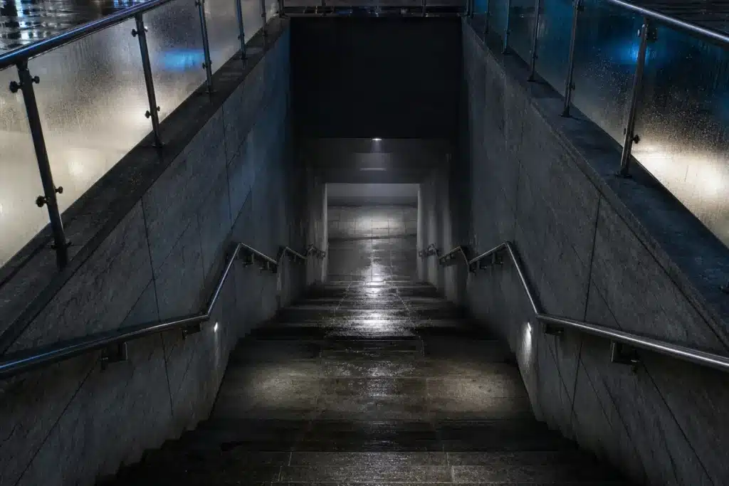Stone staircase descending into a dim passage, symbolizing SUI's drop from its all-time high