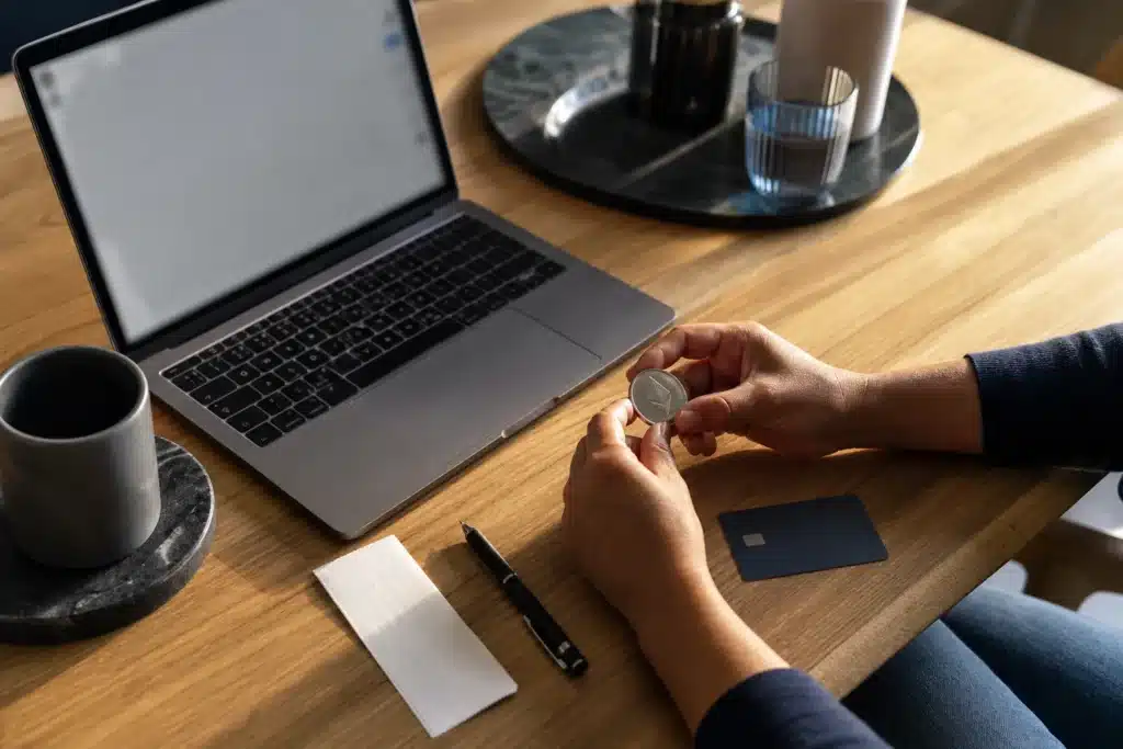 An editorial illustration of a laptop, face-down payment card and blank receipt.