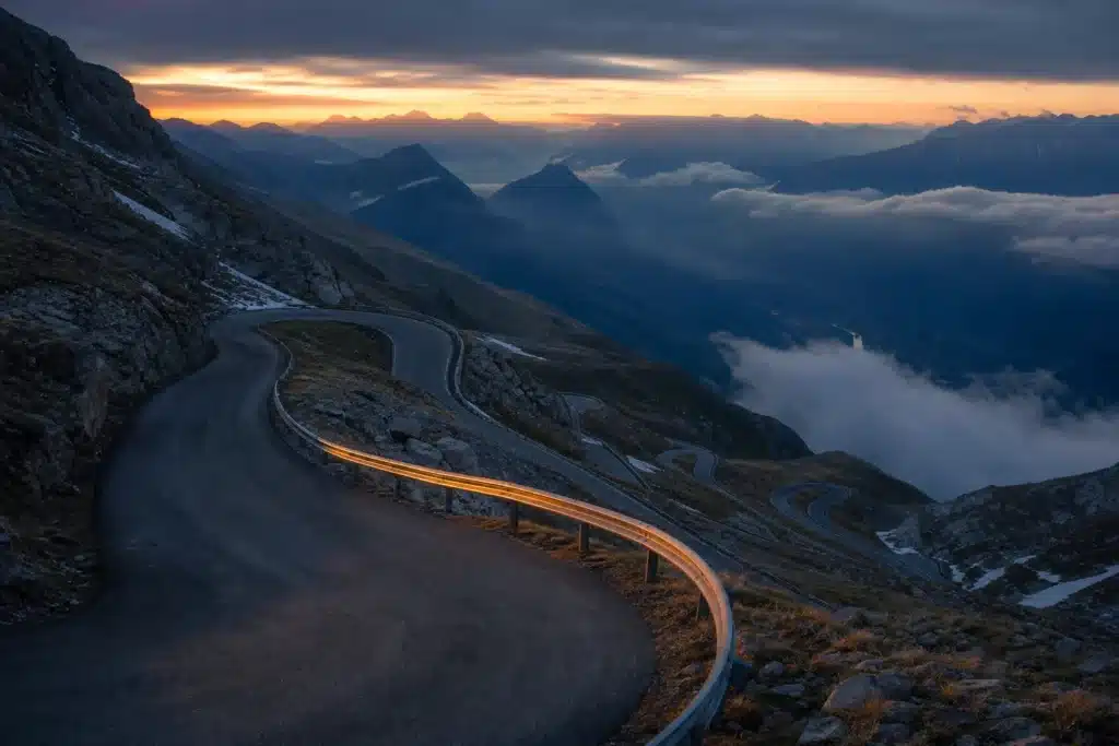 Litecoin Price Prediction 2026: LTC Scenarios, Key Levels and Risks 8 Winding mountain road at dusk symbolising Litecoin's price swings since its 2021 peak